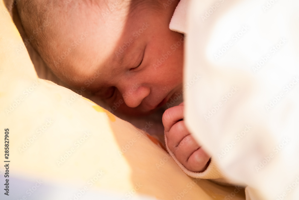 Sleeping newborn baby. Cute little girl one day old. Adorable lying on side covered with blanket. Sleeping newborn baby. Cute little girl one day old. Adorable lying on side covered with blanket.