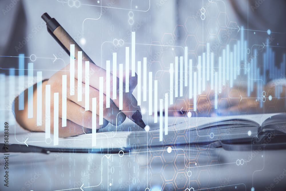Multi exposure of woman's hands making notes with forex graph hologram. Concept stock market analysis. Multi exposure of woman's hands making notes with forex graph hologram. Concept stock market analysis.