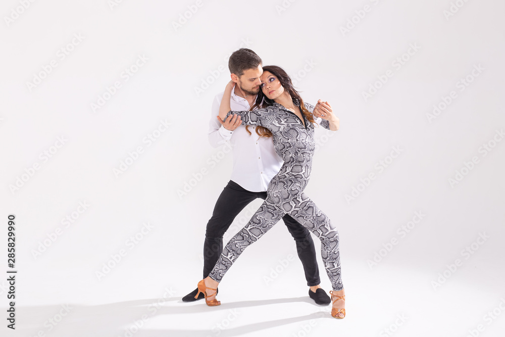 Young love couple dancing social danse kizomba or bachata over white background with copy space Young love couple dancing social danse kizomba or bachata over white background with copy space