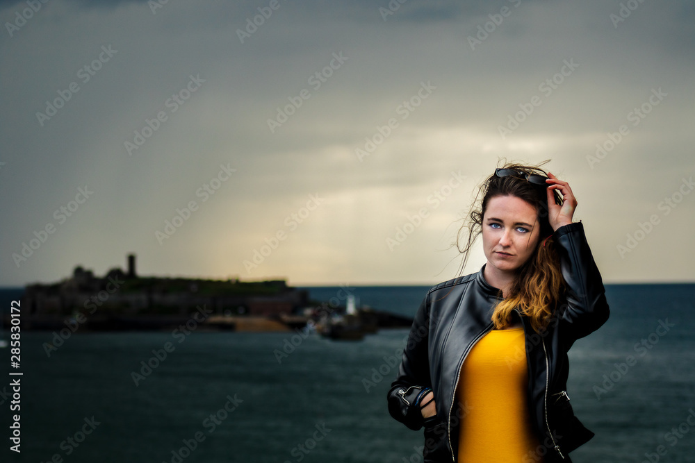Beautiful Girl in front of castle on dark stormy day