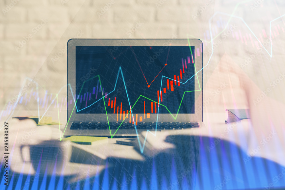 Stock market graph and table with computer background. Multi exposure. Concept of financial analysis.