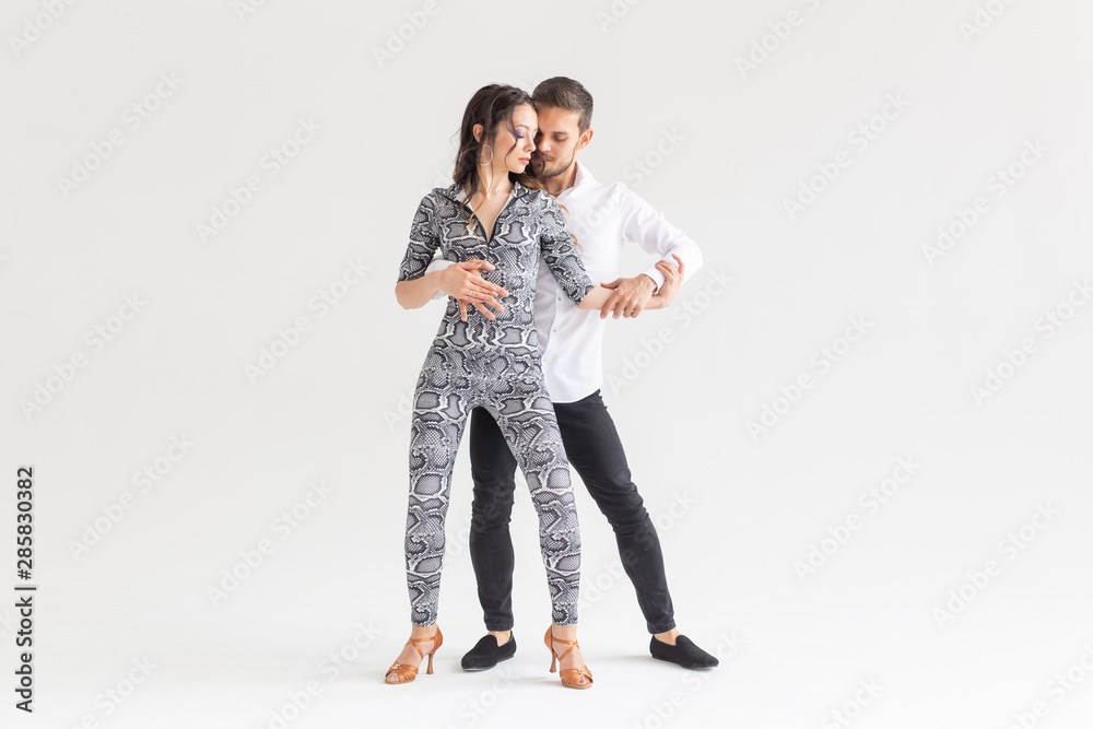 Social dance concept - Active happy adults dancing bachata together over white background with copy space Social dance concept - Active happy adults dancing bachata together over white background with copy space