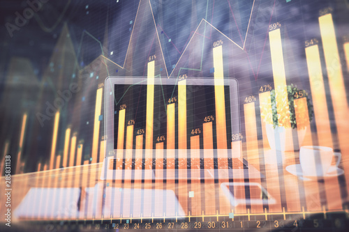 Stock market graph and table with computer background. Multi exposure. Concept of financial analysis.