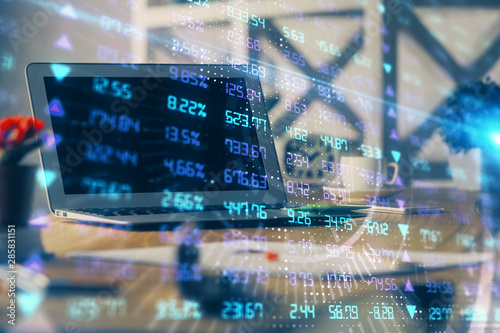 Financial graph colorful drawing and table with computer on background. Multi exposure. Concept of international markets.