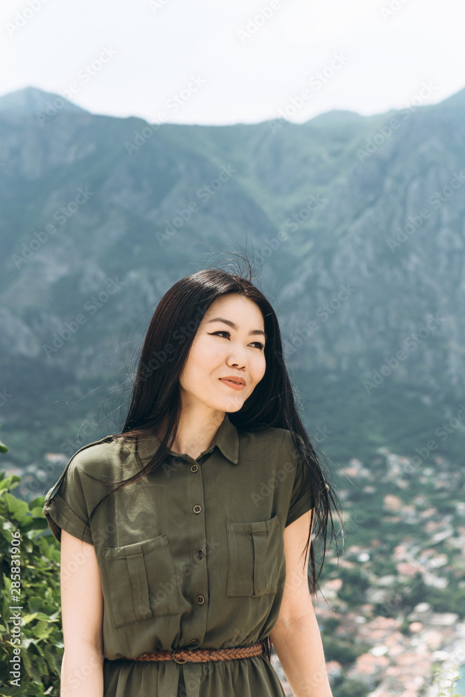 Portrait of a young beautiful Kazakh girl on a background of mountains