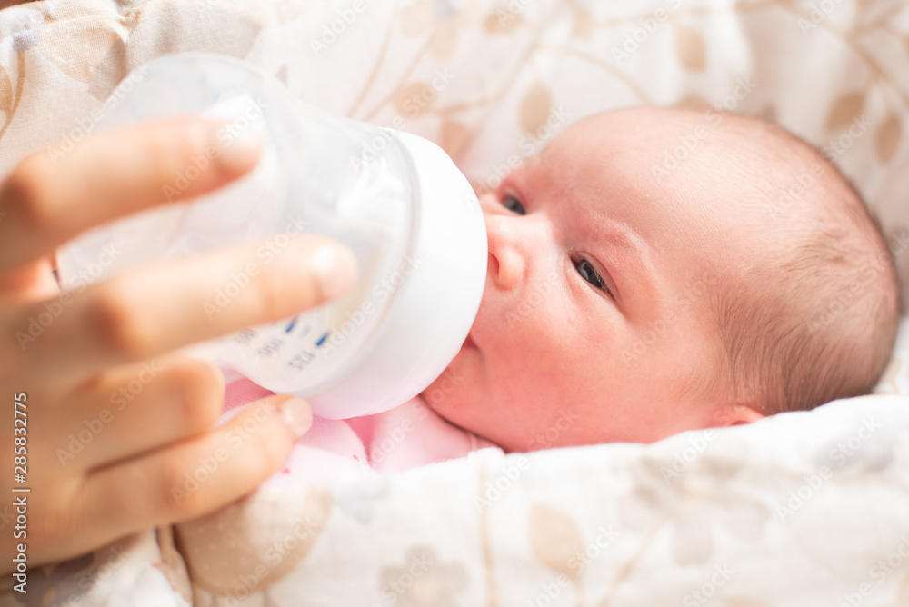 Mother feeding four days old newborn baby girl. Mother feeding four days old newborn baby girl.