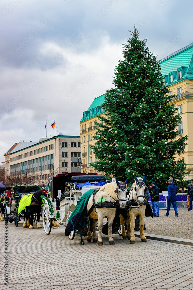 Carriage with horses on Pariser Platz at Brandenburg gate Berlin