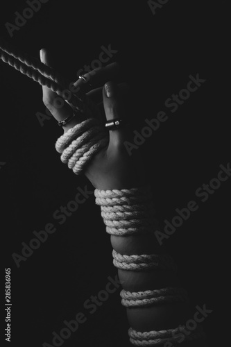 Kinbaku women's hands tied with rope