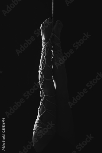 Kinbaku women's feet tied with rope