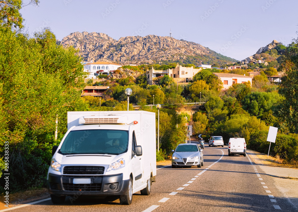 Rv cavaran and cars on road in Costa Smeralda Sardinia