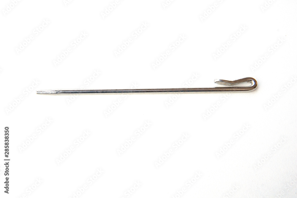 Needle like metal object isolated on white background. This can be used for sewing as well as tidying hair for Sikh boys and men. Needle like metal object isolated on white background. This can be used for sewing as well as tidying hair for Sikh boys and men.