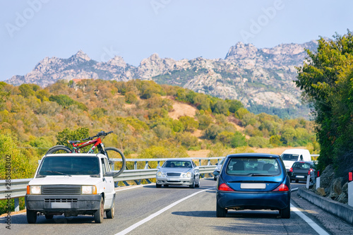 Car with bicycle in road in Costa Smeralda
