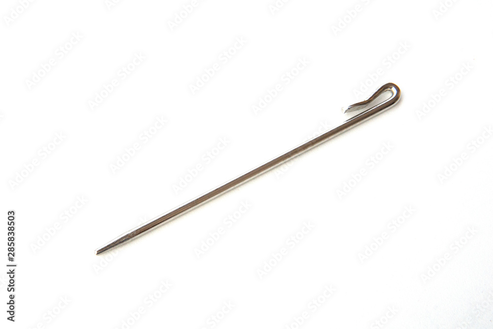 Needle like metal object isolated on white background. This can be used for sewing as well as tidying hair for Sikh boys and men. Needle like metal object isolated on white background. This can be used for sewing as well as tidying hair for Sikh boys and men.