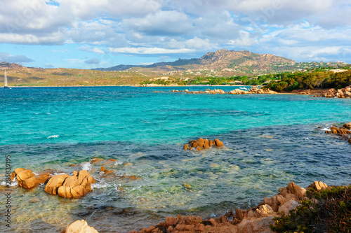 Romantic sunny sunrise at Capriccioli Beach in