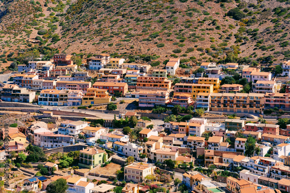 Cityscape of Buggerru city with houses architecture at hills