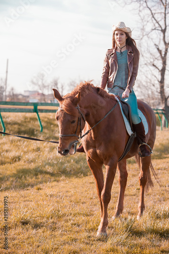 Woman sitting horse. Day.