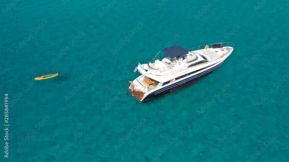 Aerial drone photo of luxury yacht docked in tropical Caribbean bay with turquoise open ocean sea Aerial drone photo of luxury yacht docked in tropical Caribbean bay with turquoise open ocean sea