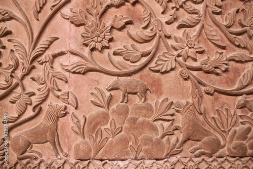 Ancient stone bas-relief with flowers and animals in Junagarh fort in Bikaner, Rajasthan, India
