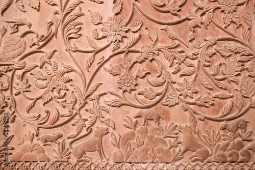 Ancient stone bas-relief with flowers and animals in Junagarh fort in Bikaner, Rajasthan, India