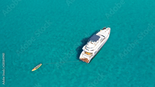 Aerial drone photo of luxury yacht docked in tropical Caribbean bay with turquoise open ocean sea © aerial-drone
