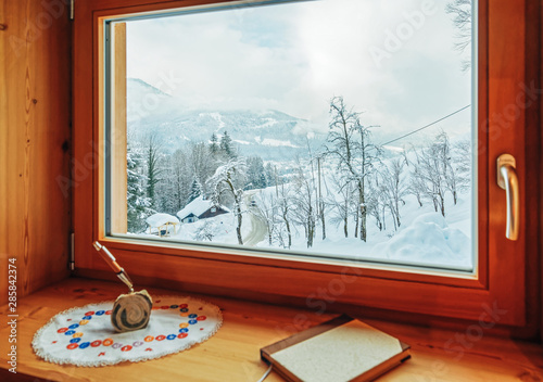 Window with view on Alpine mountains in snowy winter Austria