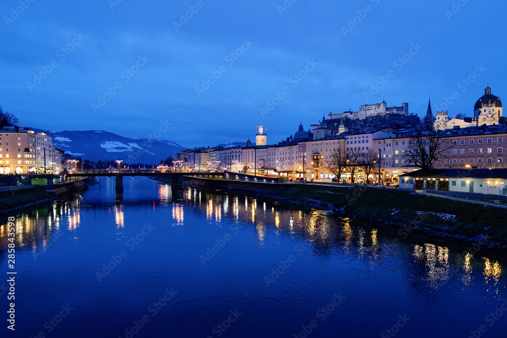 Old city and Hohensalzburg castle near Salzach River Salzburg evening