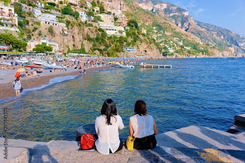Ladies sitting at Beach in Positano town Amalfi Coast