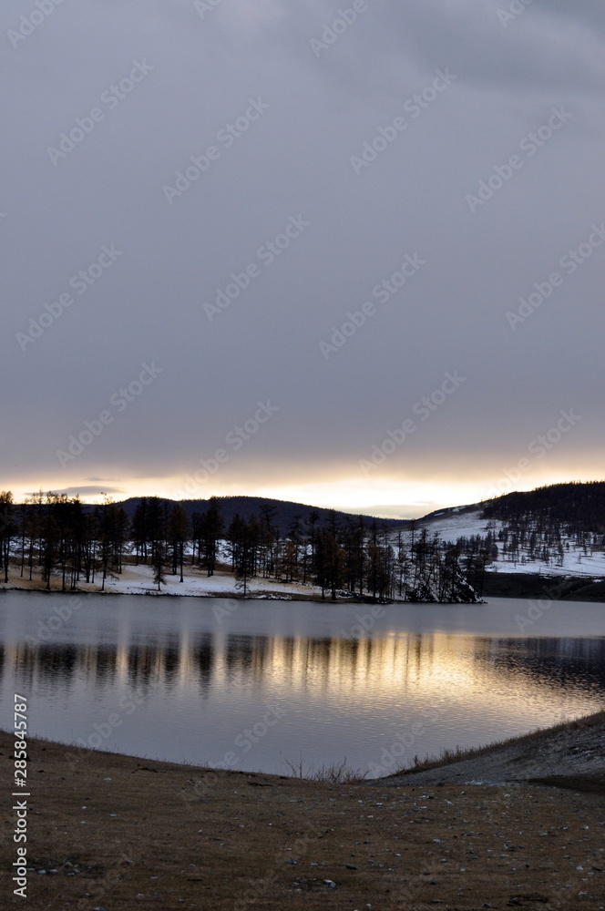 lake at sunset with reflection and snow (Lake Khuvsgul, Mongolia - Siberia)