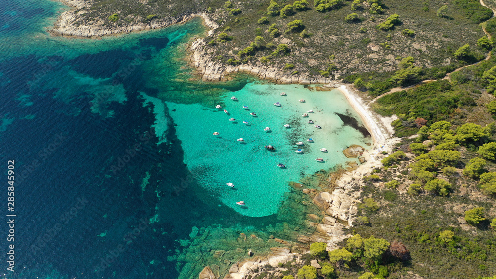 Aerial drone panoramic photo of iconic exotic bay known as blue lagoon in Diaporos island with turquoise clear sea, Vourvourou, Sithonia Peninsula, Halkidiki, North Greece