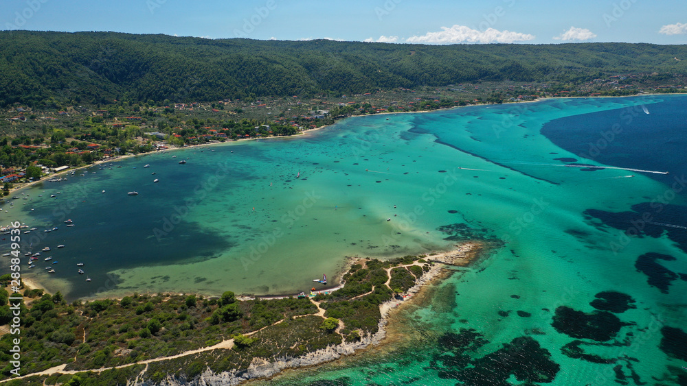 Naklejka premium Aerial drone panoramic photo of iconic bay with turquoise frozen waves of Vourvourou in Sithonia Peninsula, Halkidiki, North Greece
