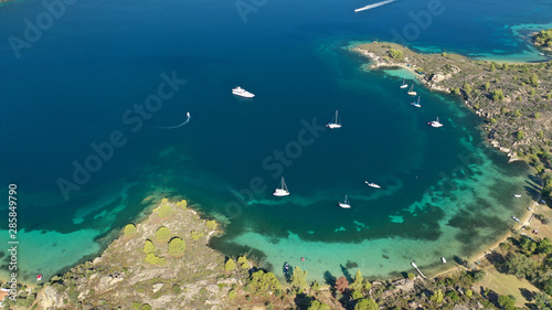 Aerial drone panoramic photo of iconic bay with turquoise frozen waves of Vourvourou in Sithonia Peninsula, Halkidiki, North Greece