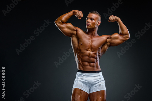 Young Handsome Muscular Men Flexing Muscles photo