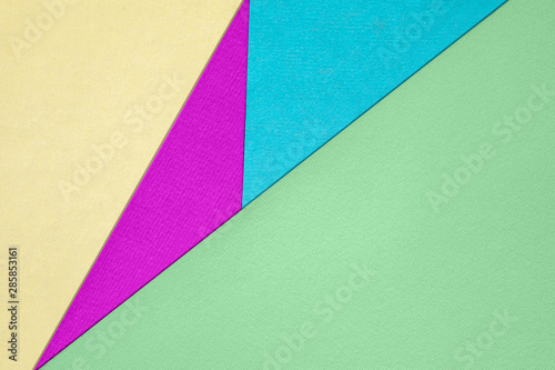Abstract different bright colored paper backgrounds with place for text. Diagonal geometric composition. Top view.