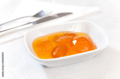 apricot jam on a plate on a white background