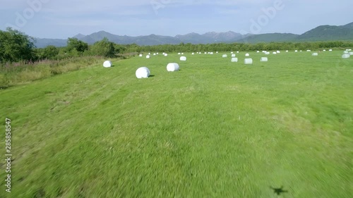 Drone  conducts  video shooting on agricultural fields where I harvest hay.