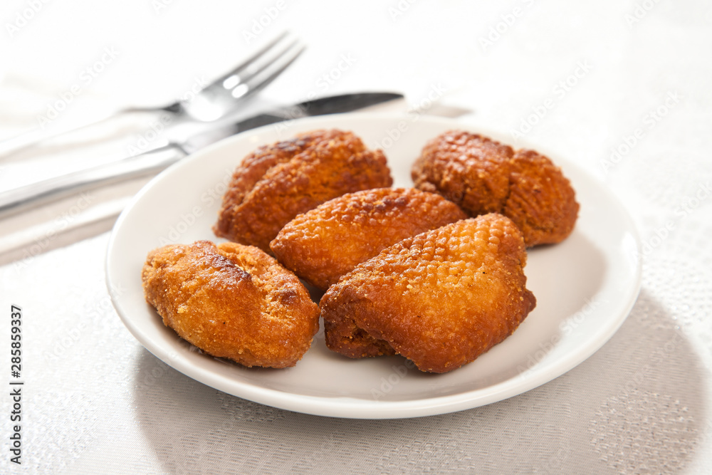 fried dough (Bishi) on a plate on a white background