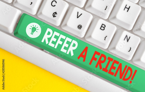 Text sign showing Refer A Friend. Business photo text direct someone to another or send him something like gift White pc keyboard with empty note paper above white background key copy space photo