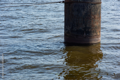 Metal column for mooring vessels in water © savelov