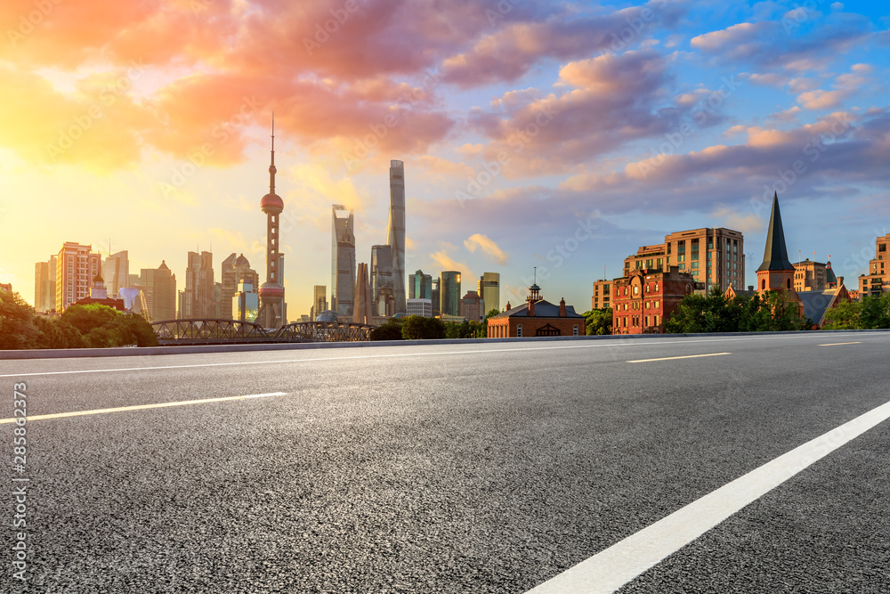 Empty highway and beautiful city buildings scenery at sunrise in Shanghai,China.