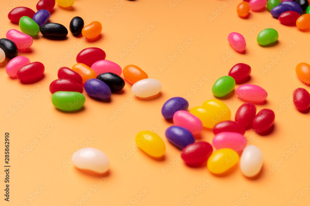 colourful jelly beans candies orange background Top view colourful jelly beans candies orange background Top view
