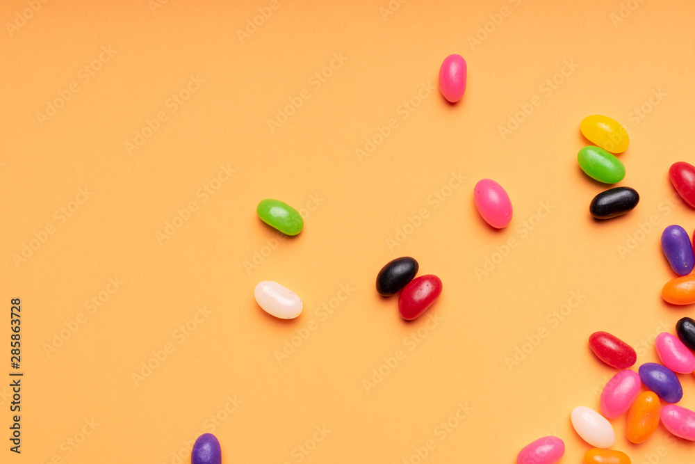 colourful jelly beans candies orange background Top view colourful jelly beans candies orange background Top view