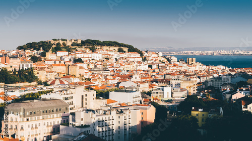 Fototapeta Naklejka Na Ścianę i Meble -  Panoramic view over the center of Lisbon from the viewpoint called: Miradouro de Sao Pedro de Alcantara featuring the Baixa neighbourhood and Castelo Sao Jorge
