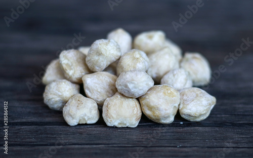 Candlenut or aleurites moluccana on wood background. photo