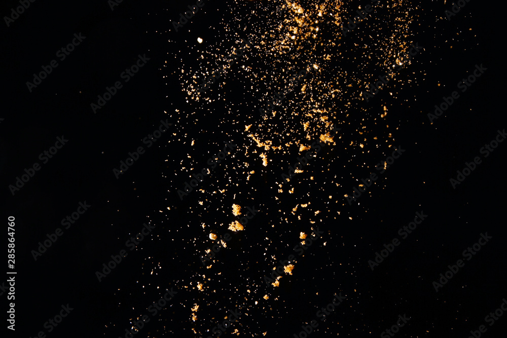 Powder particles on black background