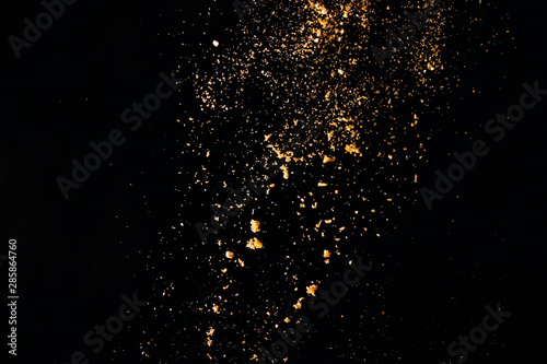 Powder particles on black background