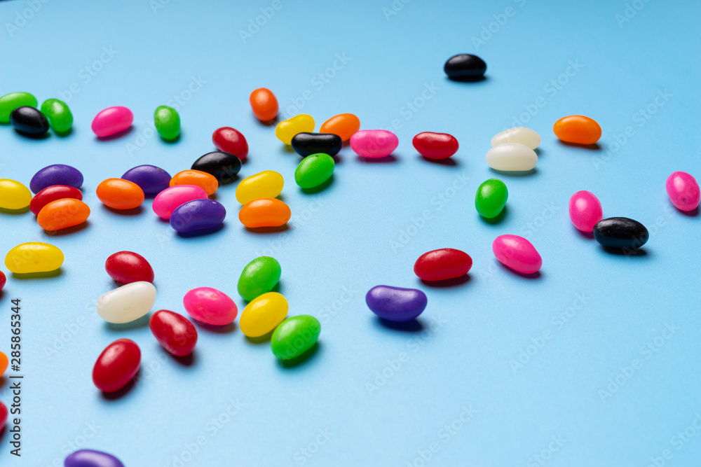 colourful jelly beans candies blue background Top view colourful jelly beans candies blue background Top view