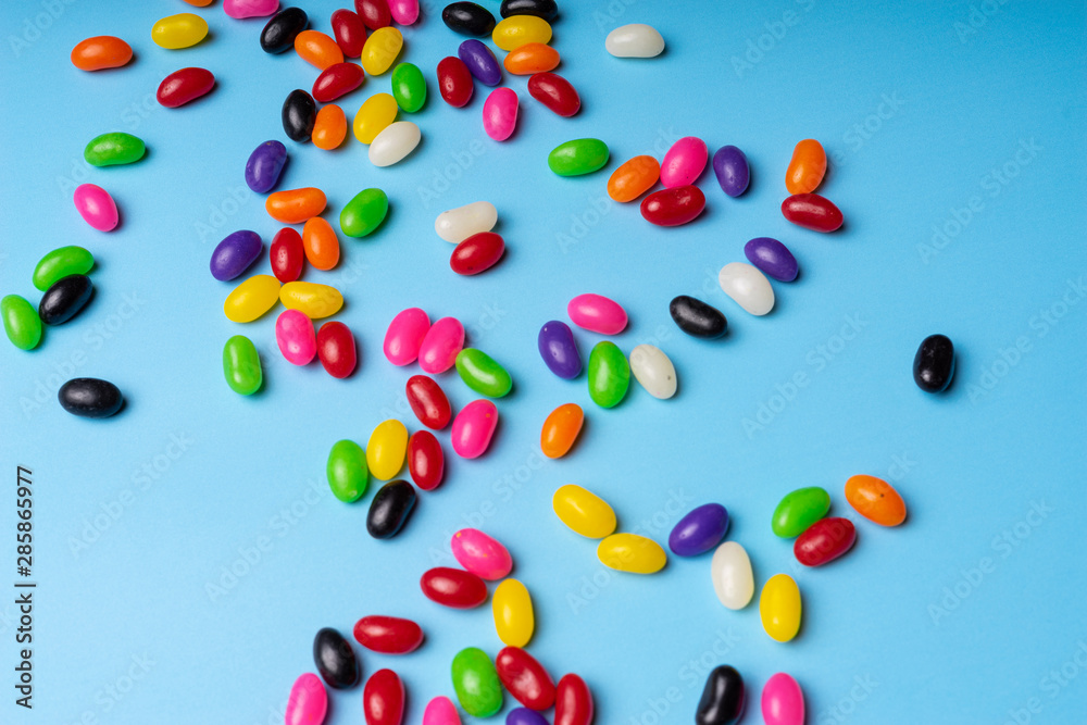 colourful jelly beans candies blue background Top view colourful jelly beans candies blue background Top view
