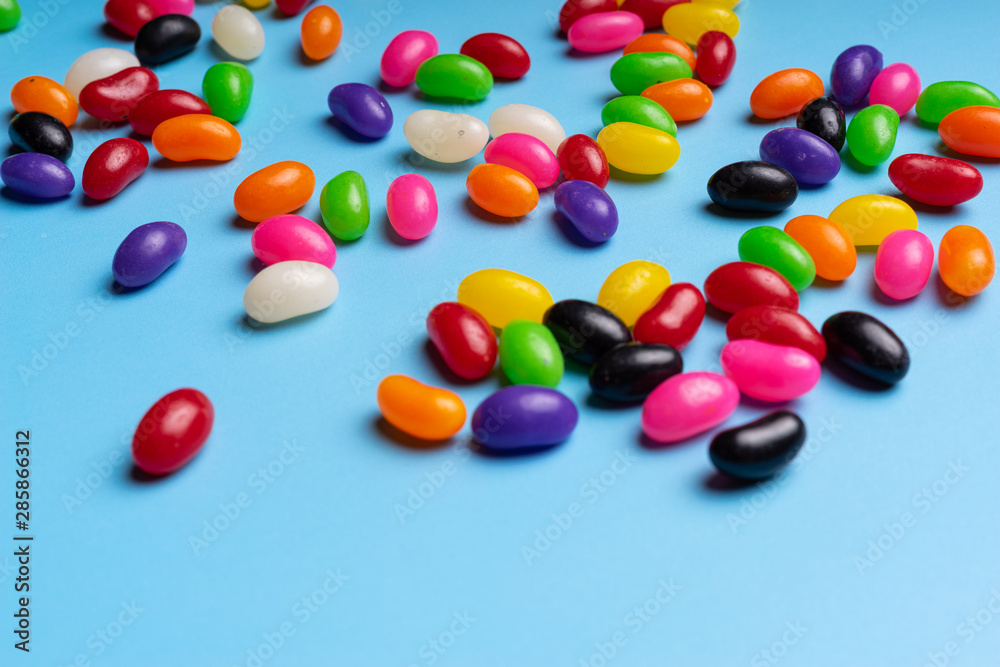 colourful jelly beans candies blue background Top view colourful jelly beans candies blue background Top view