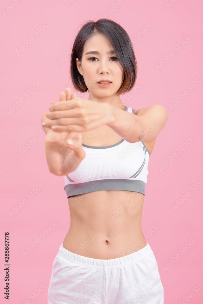 sport woman standing warm-up and stretch body before doing exercise on pink backgrounds, fitness concept, sport concept sport woman standing warm-up and stretch body before doing exercise on pink backgrounds, fitness concept, sport concept