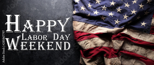 US American flag on worn black background. For USA Labor day celebration. With Happy Labor Day Weekend text.